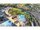 Overhead view of outdoor pool with blue umbrellas, lush landscaping and scenic views of the golf course at 2776 White Sage Dr, Henderson, NV 89052