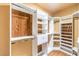 Spacious walk-in closet with custom shelving and wood paneling for an organized wardrobe at 2776 White Sage Dr, Henderson, NV 89052