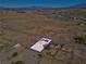 Aerial view showcases desert property outlined in blue, featuring a home with solar panels and spacious land at 2831 Goldrush St, Pahrump, NV 89048