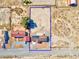 Overhead view of a property with a large fenced yard, house with solar panels, desert landscape outlined in blue at 2831 Goldrush St, Pahrump, NV 89048