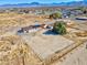 Expansive desert property featuring fenced yard, home with solar panels, and scenic mountain backdrop in a serene location at 2831 Goldrush St, Pahrump, NV 89048