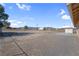 Wide desert backyard featuring gravel landscaping, a shed, and open space for outdoor activities at 2831 Goldrush St, Pahrump, NV 89048