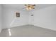 Bright bedroom with tile flooring, ceiling fan, and a door for access at 2831 Goldrush St, Pahrump, NV 89048