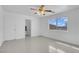 Bright bedroom with tile flooring, ceiling fan and a peek into the bathroom at 2831 Goldrush St, Pahrump, NV 89048