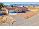 Charming one-story home with a gravel front yard, an attached two-car garage, and scenic mountain views at 2831 Goldrush St, Pahrump, NV 89048