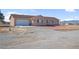 Charming single-story home featuring a two-car garage and low maintenance desert landscaping at 2831 Goldrush St, Pahrump, NV 89048