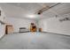Open garage space with shelving, lighting, and a side door, providing ample room for storage at 2831 Goldrush St, Pahrump, NV 89048