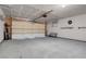 Spacious garage with a large door, overhead lighting, and ample space for parking and storage at 2831 Goldrush St, Pahrump, NV 89048