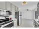 Bright kitchen with stainless steel appliances, tile flooring, and gray cabinets at 2831 Goldrush St, Pahrump, NV 89048