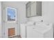 Bright laundry area with white washer, dryer, cabinets, and an exterior door to the backyard at 2831 Goldrush St, Pahrump, NV 89048