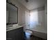 Bathroom with sink, toilet, mirror, and shower-tub combo at 3417 Civic Center Dr # B, North Las Vegas, NV 89030