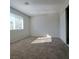 Bedroom featuring neutral walls, plush carpeting, and a large window at 3417 Civic Center Dr # B, North Las Vegas, NV 89030