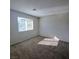 Sunlit bedroom featuring neutral walls, plush carpeting, and a large window at 3417 Civic Center Dr # B, North Las Vegas, NV 89030
