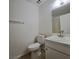 Simple bathroom featuring a toilet, vanity with sink, and a large mirror at 3523 Mercury St # A, North Las Vegas, NV 89030