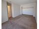 Bedroom features neutral walls, carpeting, and a closet with shelving at 3523 Mercury St # A, North Las Vegas, NV 89030