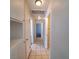 Well-lit hallway featuring tile flooring, built-in storage, and access to various rooms at 3523 Mercury St # A, North Las Vegas, NV 89030