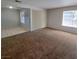 Inviting living room featuring a mix of carpet and tile flooring, and plenty of natural light at 3523 Mercury St # A, North Las Vegas, NV 89030