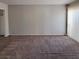 Spacious living room with wall-to-wall carpeting and a large window at 3523 Mercury St # A, North Las Vegas, NV 89030