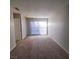 Neutral living room with carpet and sliding glass doors to the exterior at 3523 Mercury St # G, North Las Vegas, NV 89030