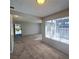 Spacious living room filled with natural light from a large window, featuring neutral walls and carpet at 3523 Mercury St # G, North Las Vegas, NV 89030