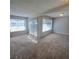 Open living room with neutral carpet, light-colored walls, large windows for plenty of natural light at 3523 Mercury St # G, North Las Vegas, NV 89030