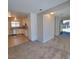 Open concept living space with updated kitchen featuring tile floor flowing into a carpeted living room at 3523 Mercury St # G, North Las Vegas, NV 89030