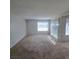 Large living room with plush carpeting, bright window with blinds, and plenty of natural light at 3523 Mercury St # G, North Las Vegas, NV 89030