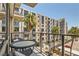 Relaxing balcony area featuring seating, a table, and a view of palm trees and the surrounding buildings at 353 E Bonneville Ave # 439, Las Vegas, NV 89101