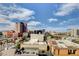 Panoramic cityscape view showcasing the urban skyline under a bright blue sky with scattered clouds at 353 E Bonneville Ave # 904, Las Vegas, NV 89101