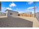 A large gravel backyard with detached garage and wood fence providing privacy and ample space at 364 Upland Blvd, Las Vegas, NV 89107