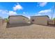 Spacious backyard features low maintenance gravel landscaping, detached garages, and block wall at 364 Upland Blvd, Las Vegas, NV 89107