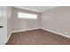 A clean bedroom with neutral paint and laminate floors, natural light from window at 364 Upland Blvd, Las Vegas, NV 89107