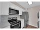 Updated kitchen features stainless steel appliances, granite countertops, and white cabinets at 364 Upland Blvd, Las Vegas, NV 89107