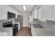 Bright kitchen with modern appliances, tile backsplash and stacked washer/dryer at 364 Upland Blvd, Las Vegas, NV 89107