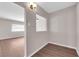 Neutral room featuring laminate floors, updated lighting, and a view of adjacent space at 364 Upland Blvd, Las Vegas, NV 89107