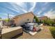 Backyard with a hot tub and storage, surrounded by gravel and some greenery at 388 Coronado Dr, Henderson, NV 89015