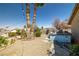 A well-maintained backyard with gravel, palm trees, and a light blue jacuzzi at 388 Coronado Dr, Henderson, NV 89015