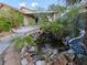 Lush backyard featuring a garden, greenery, and a soothing water feature at 388 Coronado Dr, Henderson, NV 89015
