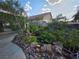 Backyard garden with rocks, greenery, and a well manicured walkway at 388 Coronado Dr, Henderson, NV 89015