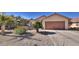 Charming single-story home with a well-maintained front yard, desert landscaping, and an attached two-car garage at 388 Coronado Dr, Henderson, NV 89015