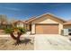 Single-story home featuring a tile roof, a two-car garage and desert landscaping at 388 Coronado Dr, Henderson, NV 89015