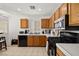 Efficient kitchen design with stainless steel microwave and oak cabinets at 388 Coronado Dr, Henderson, NV 89015