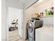 Well-equipped laundry room with modern washer and dryer, plus extra space for storage at 388 Coronado Dr, Henderson, NV 89015