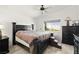 Comfortable main bedroom with a sleek black bed frame and a window offering natural light at 388 Coronado Dr, Henderson, NV 89015