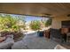 Covered patio with outdoor seating, fan, and view of backyard landscaping at 388 Coronado Dr, Henderson, NV 89015