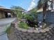 Landscaped backyard featuring a charming pond with rocks and greenery, creating a serene outdoor oasis at 388 Coronado Dr, Henderson, NV 89015