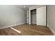 Empty bedroom with hardwood floors and a closet, offering a clean and versatile space at 4050 Pacific Harbors Dr # 209, Las Vegas, NV 89121