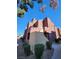 Condo exterior showcasing desert landscaping, stucco facade, and private entrance on a sunny day at 4050 Pacific Harbors Dr # 209, Las Vegas, NV 89121