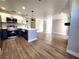 Bright, open-concept with modern kitchen featuring stainless steel appliances and center island, opening to a large living area at 4050 Pacific Harbors Dr # 209, Las Vegas, NV 89121