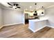 Modern kitchen with white cabinets, stainless steel appliances, granite countertops, and stylish lighting at 4050 Pacific Harbors Dr # 209, Las Vegas, NV 89121